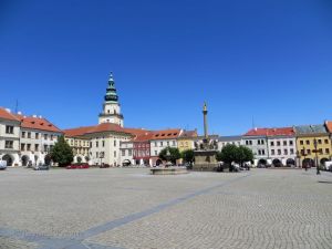 Standing on the historic main square looking towards the Archbishop's Chateau with its distinctive tower.