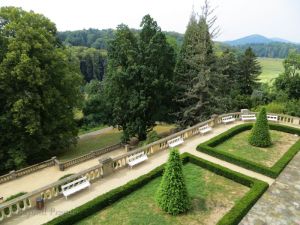 A view from a chateau balcony to the parkland surrounding it.